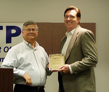 On the right, Gary Cowsert, CIO, Activant, receives his IT Executive of the Year award from Neogent's Steve Bankhead