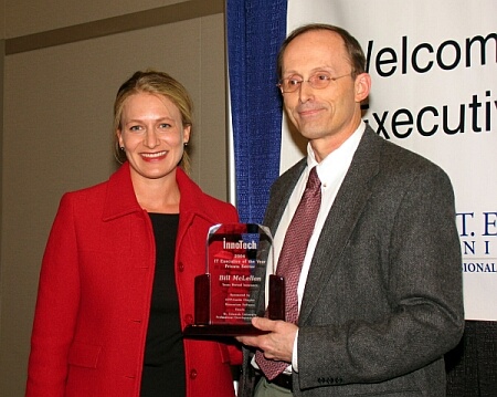 On the right, Bill McLellan, CIO of Texas Mutual Insurance, receives his IT Executive of the Year award from Oracle's Heidi Restivo