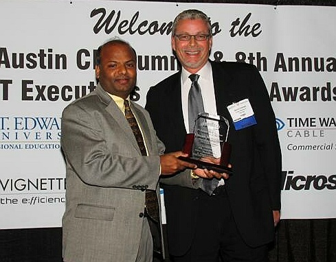 On the left, Umesh Manathkar, CIO of Silicon Labs, receives his IT Executive of the Year award from Vignette's David Graham