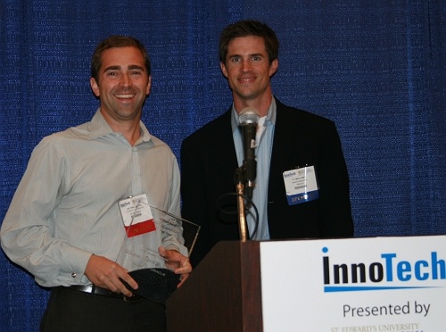 Jay Hallberg of Spiceworks receives their award from Oracle's TJ Williams