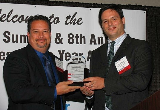 On the left, Andres Carvallo, CIO of Austin Energy is honored as Austin's IT Executive of the Year (Public Sector) by event sponsor Juniper Networks